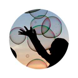 Photo showing a child playing with bubbles